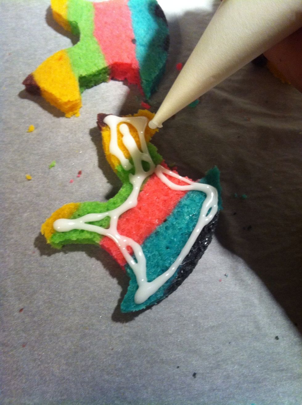 Using that icing that you made, pipe onto thin cookie slices after they have cooled and hardened into real sugar cookies.