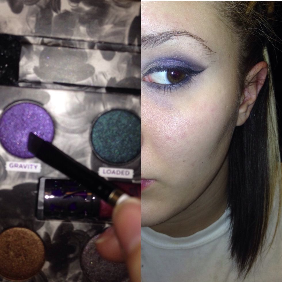 Using that liner brush apply purple under and blend