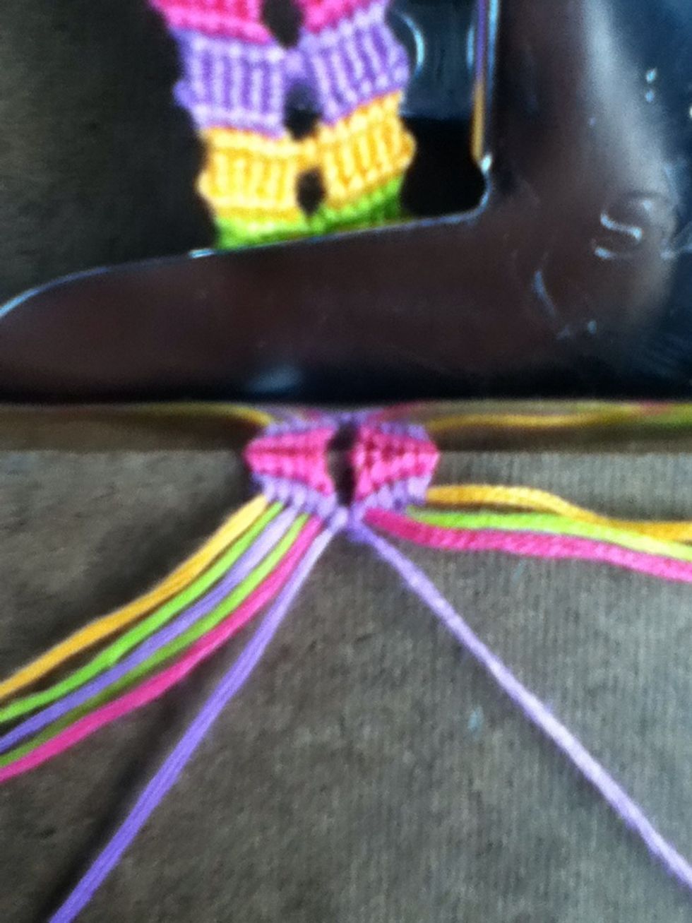 Using the 2 center strings (the purples) make a right knot.