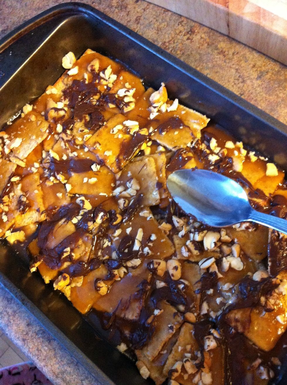 Using the back of a spoon, smooth chocolate chips as they are now melted and put the whole works in the refrigerator until toffee is hardened.