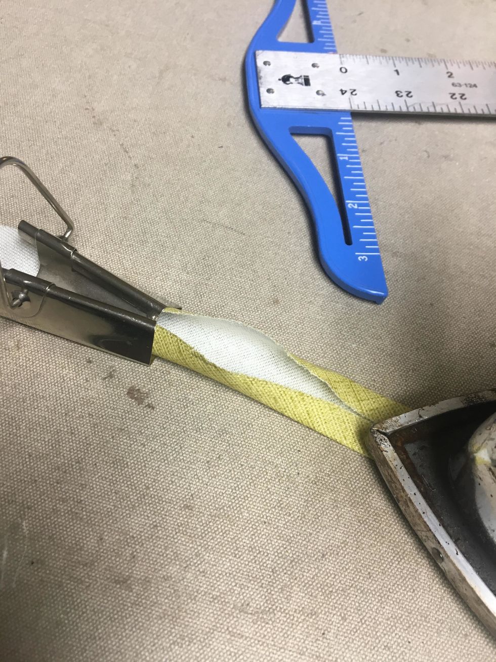 Using the bias tape maker, (available here at our website, https://bit.ly/2VBsxMZ) pull the strips through and carefully press forming the bias banding.