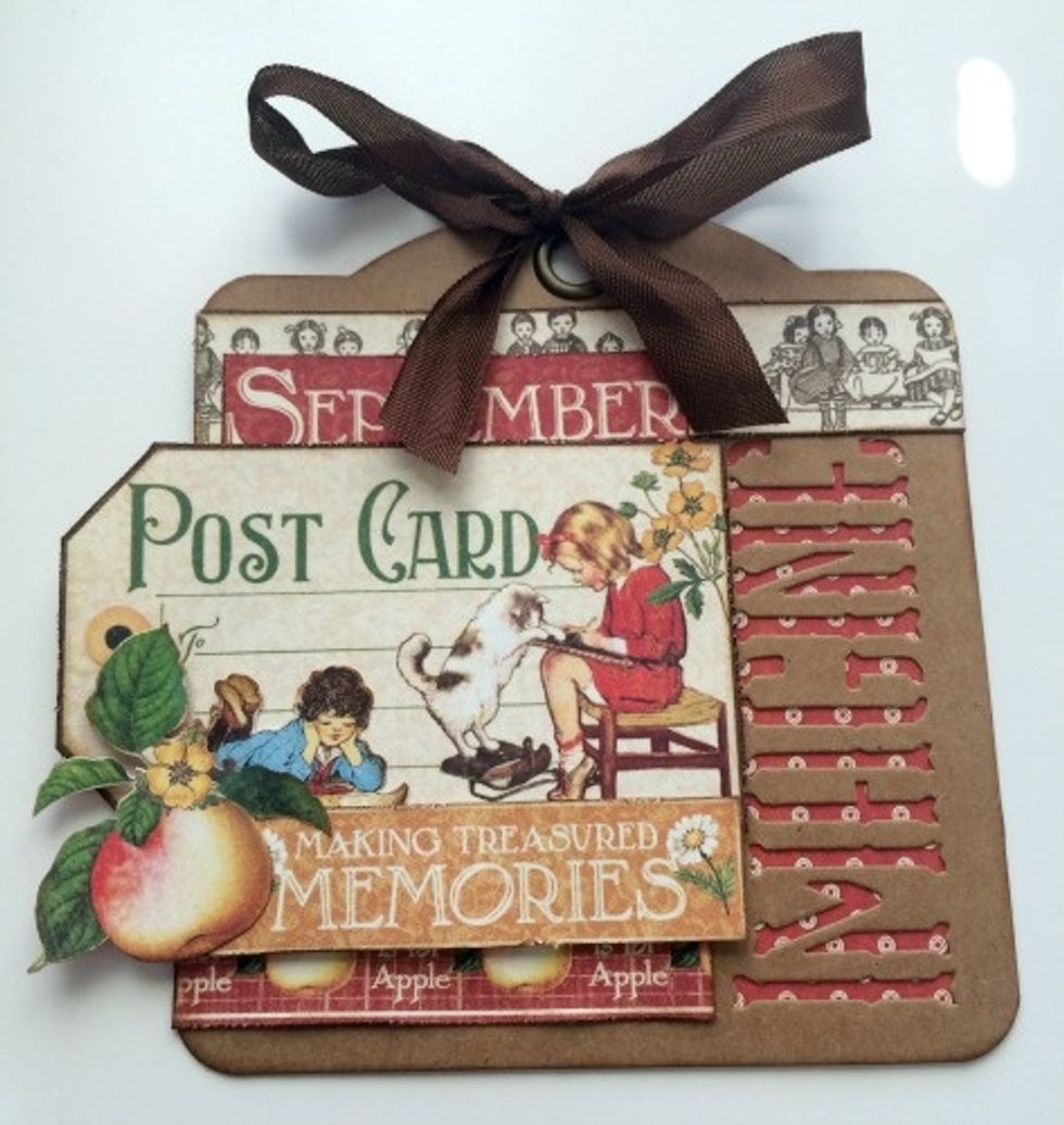 Using the brown seam binding ribbon and tie a bow at the top of the tag.