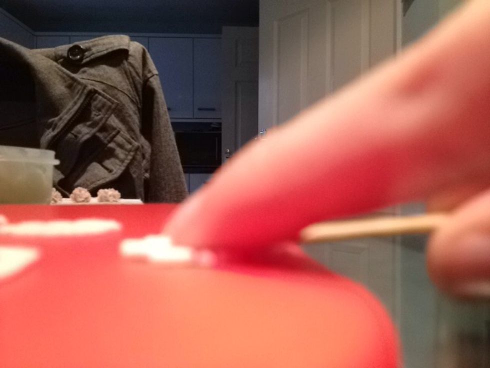 Using the cocktail stick push on the petals and rock to make little indents