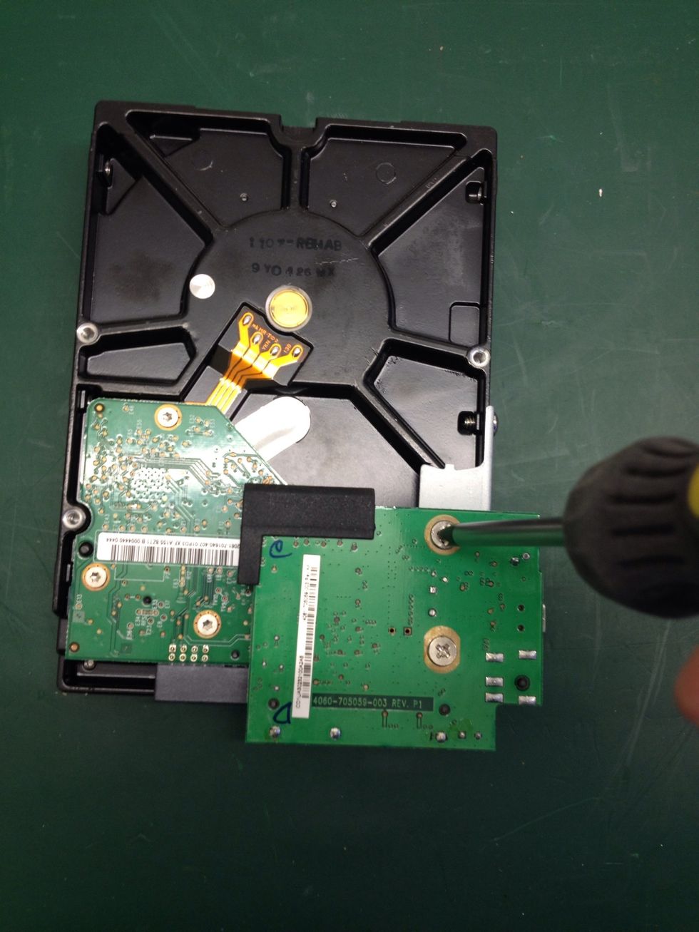 Using the cross-head screwdriver remove these two screws.