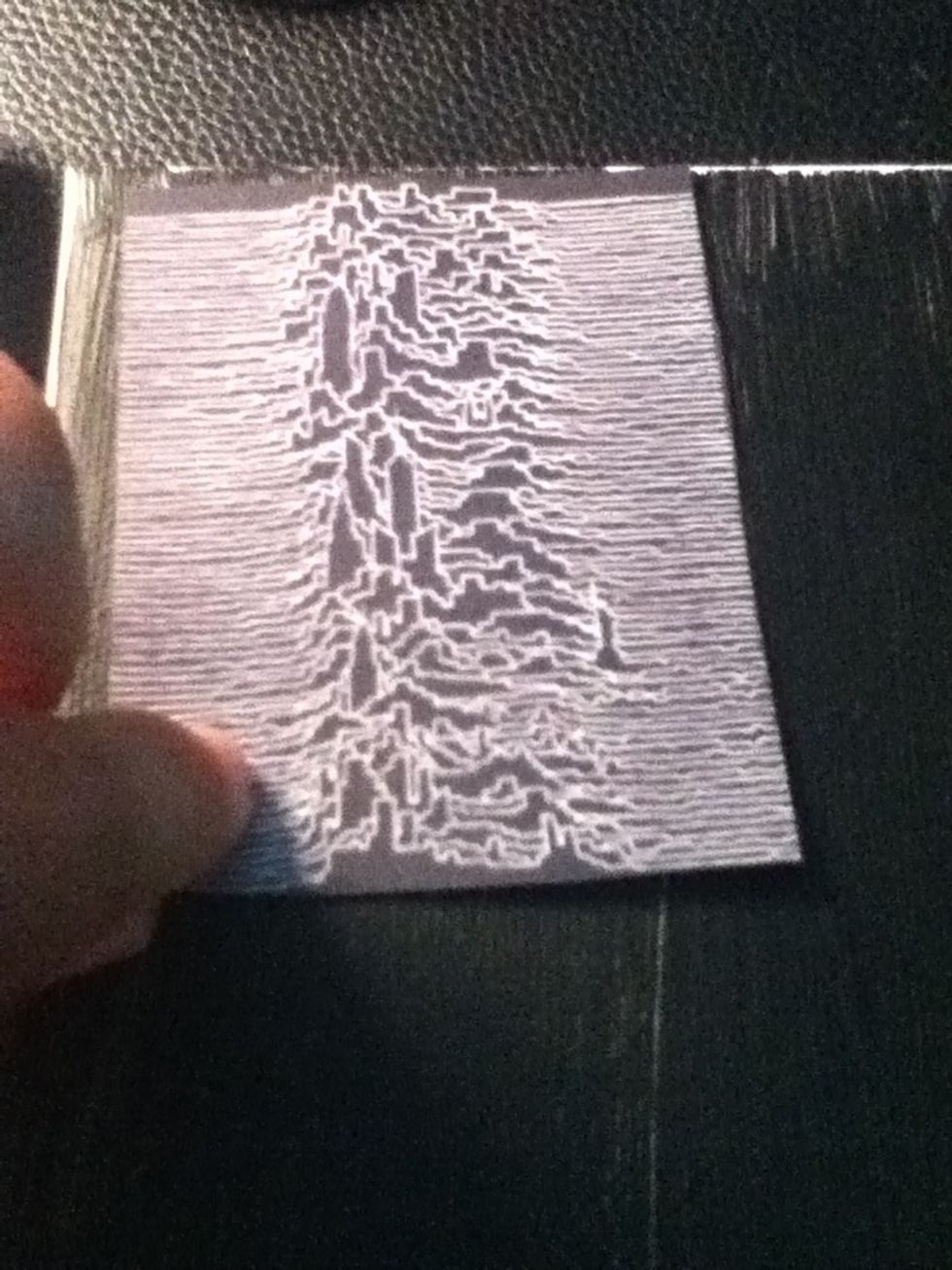 Using the double-sided tape, stick the pictures to the canvas; starting with the base pictures.
