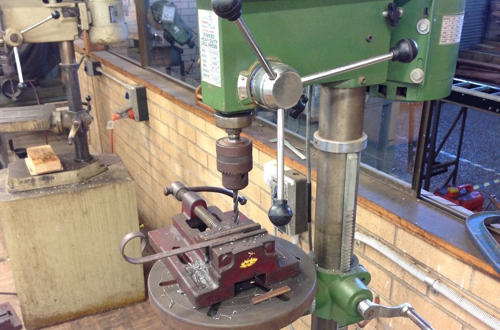 Using the drill press drill a hole in the centre of your feet and on the end of your scroll piece.