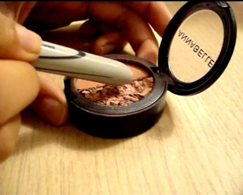 Using the end of the marker or you my use anything you like....crush the remaining make-up