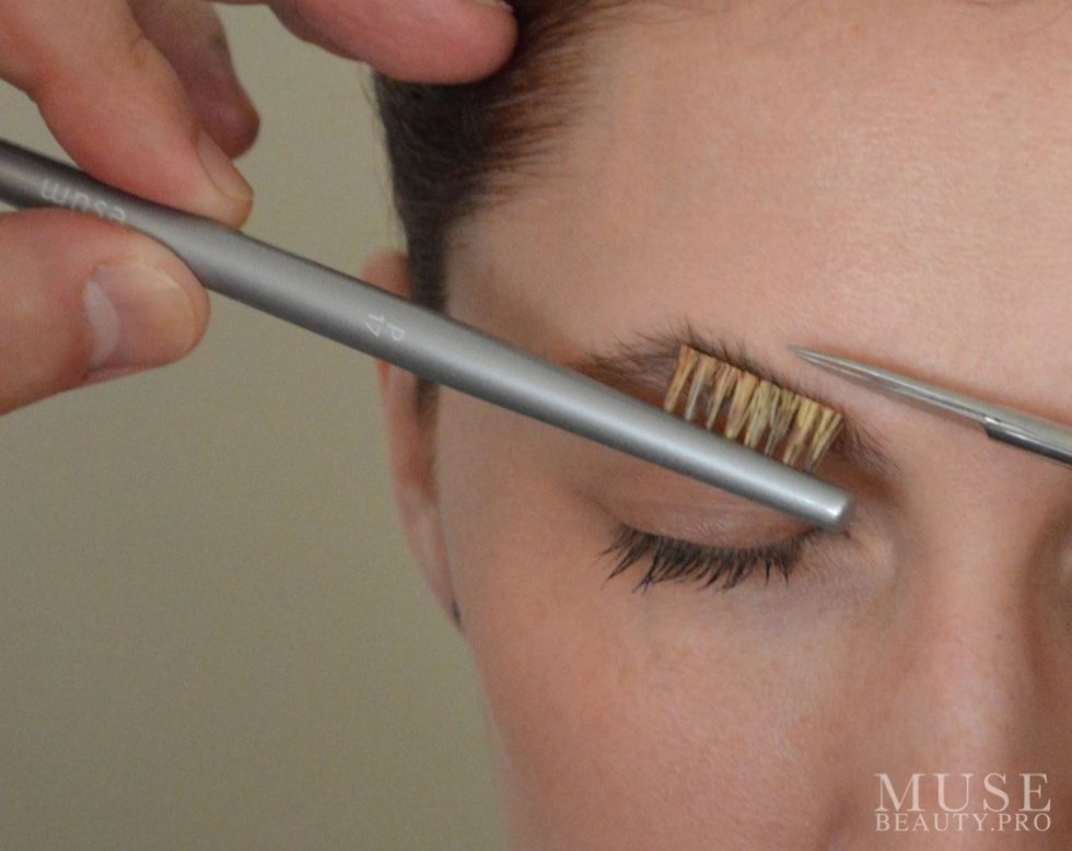 Using the ESUM P17 Brow Groom Brush brush hairs upwards and trim off the additional length with a pair of Cuterz.