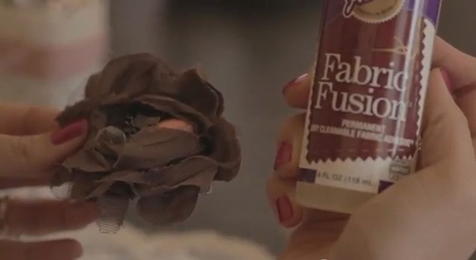 Using the fabric glue, glue on the lucite stones in the center of the faux flower.