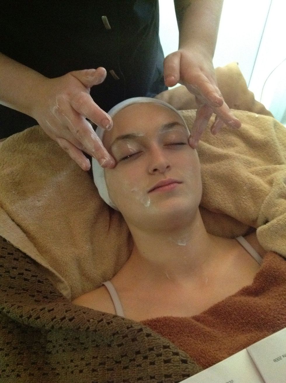 Using the fingers to apply large circular movements over the cheeks, working upwards and outwards.