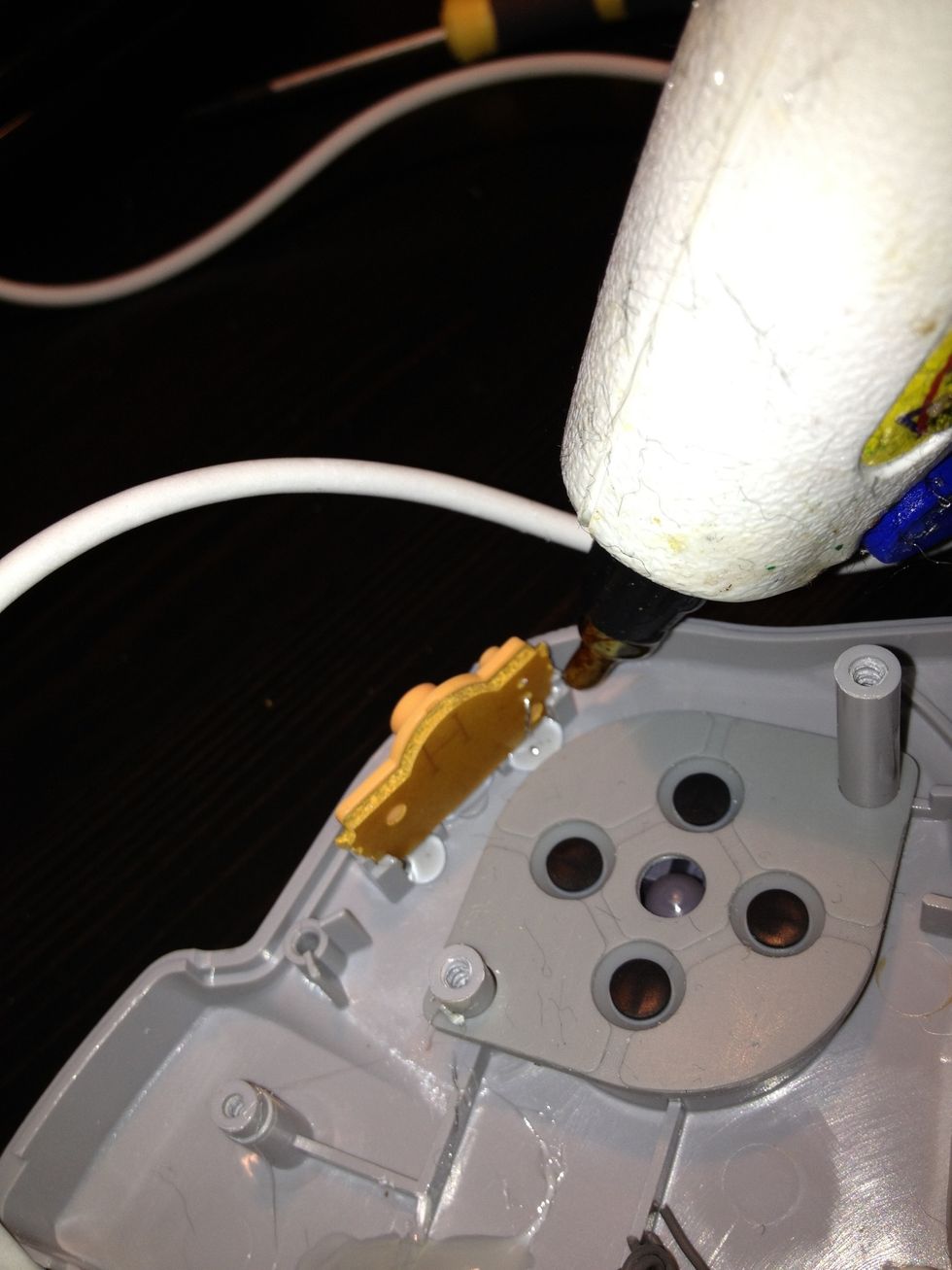 Using the glue gun, glue them into place. This allows them not to jiggle or fall out of place when the controller is closed.