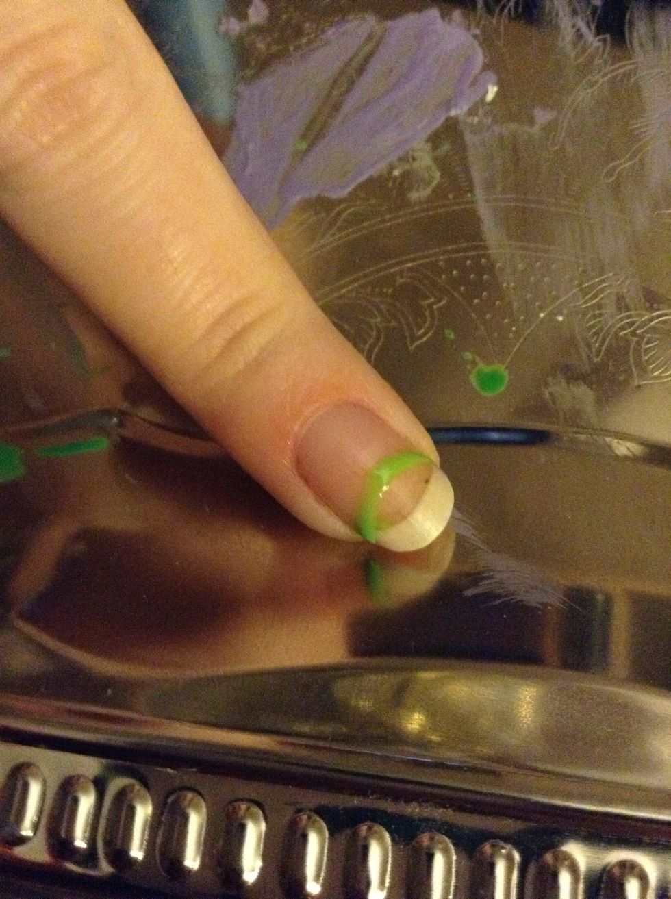 Using the green nail art brush/stripper, create a half circle just above the whites of your nail.