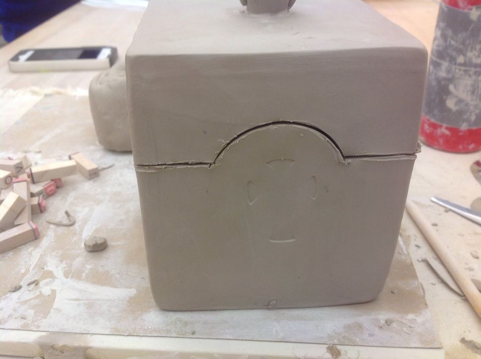 Using the knife, carefully cut through the clay all the way around.