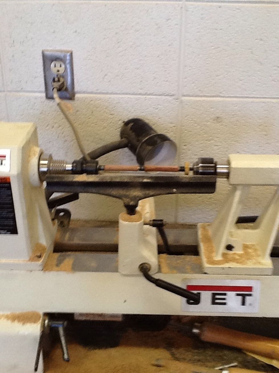 Using the lathe work down the wood until it is round
