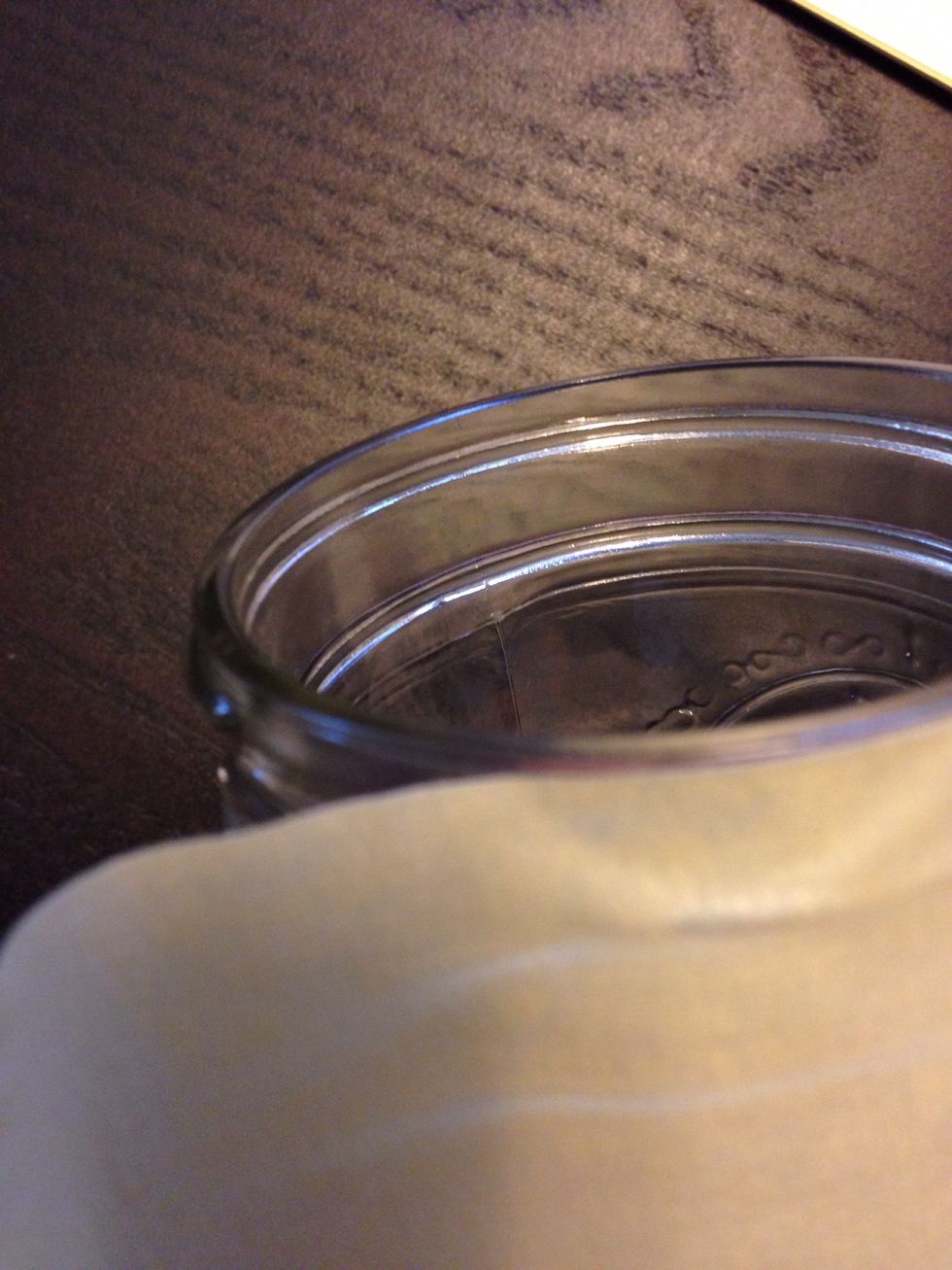 Using the masking tape, line the edges of the jar to avoid getting spray paint on the outside