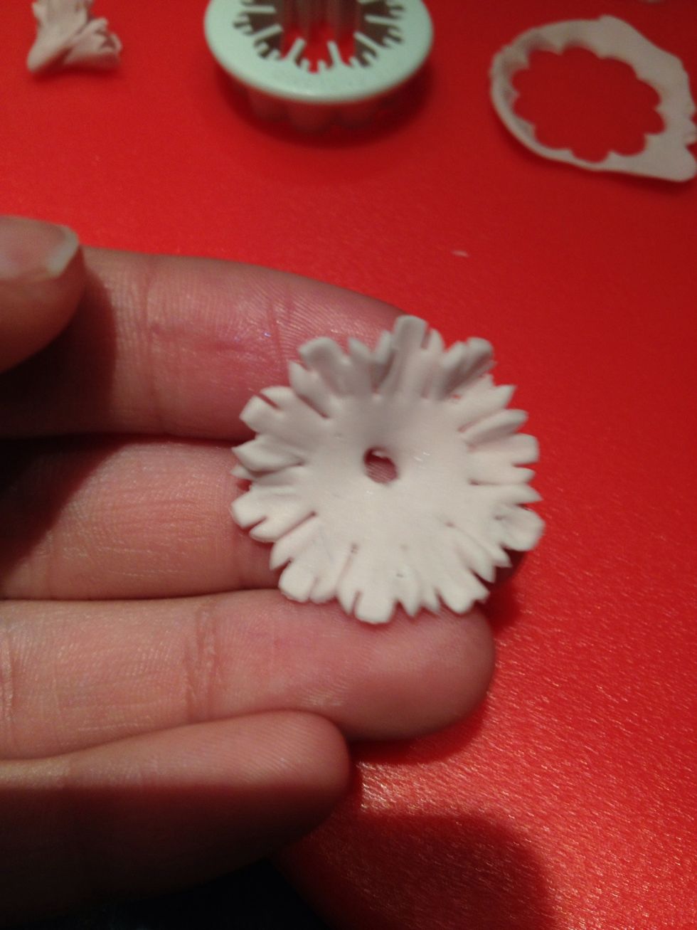 Using the paintbrush, put a hole in the middle of one and glue around the hole