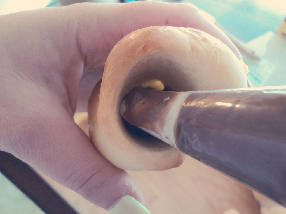 Using the pastry bag, fill the cornets up from the very inside all the way out.