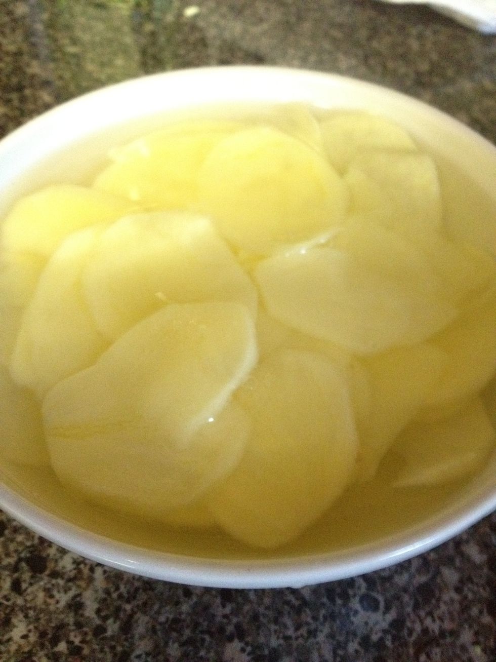 Using the peeler, make as thin slices as you can and submerge in water so they don't oxidize.