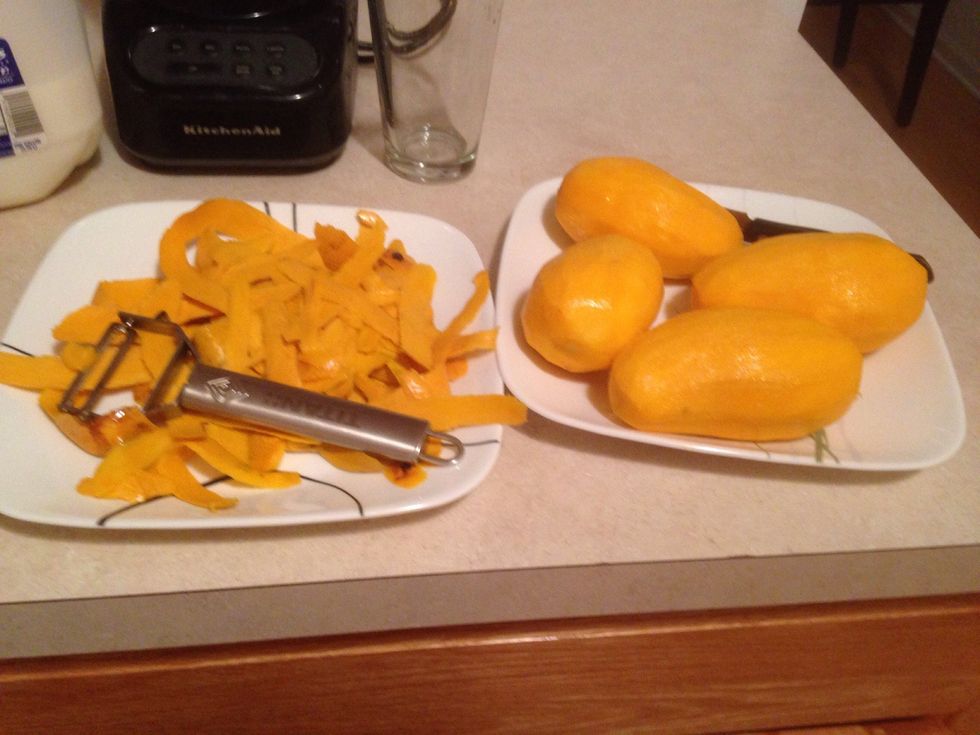Using the peeler peel the mangos