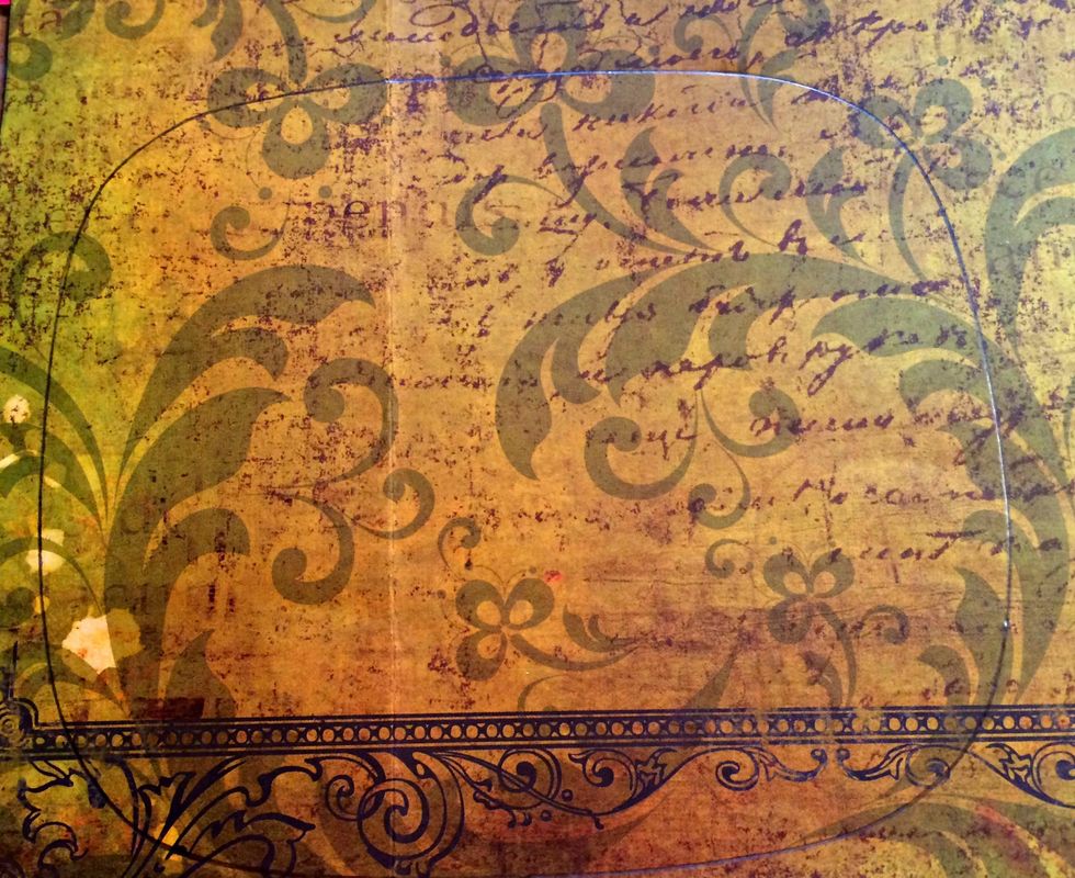 Using the piece that came in the back of the Prima Frame, trace the shape onto the scrapbook paper you have chosen for the background piece on your project, then cut it out and glue it into place.