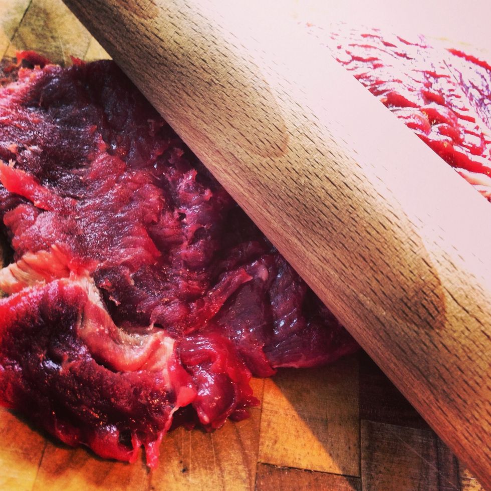 Using the pin/ hammer hit the meat evenly until flat, turn over and hit again.