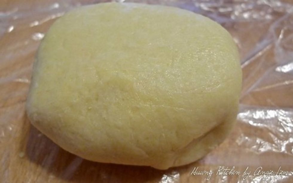 Using the plastic wrap, gather the dough together into a ball.