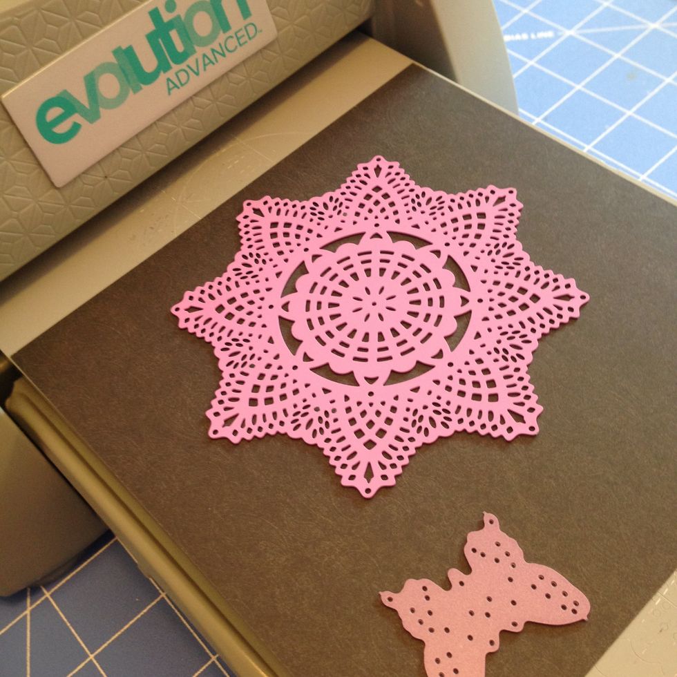 Using the Prima Doily die cut a doily from black shiny paper die, cut a black shiny butterfly from the same paper.  Set aside.