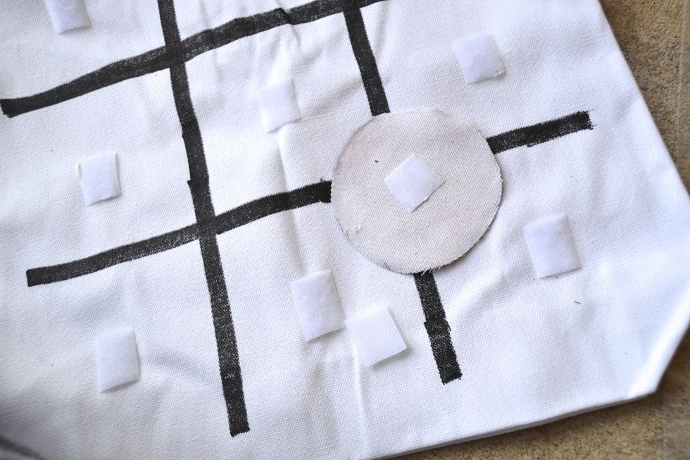 Using the same adhesive, glue the rough side of the adhesive to the back of each of your playing pieces.