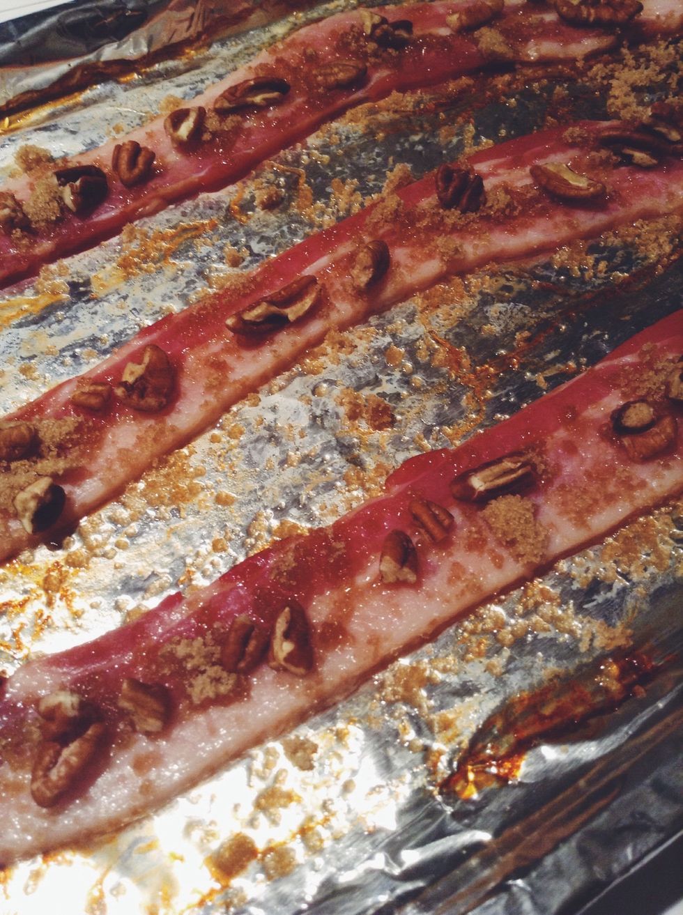 Using the same baking sheet add a few more slices of bacon. I used three. Sprinkle with brown sugar and top with pecans. Place your brownies and bacon in the oven and bake for 50 minutes.