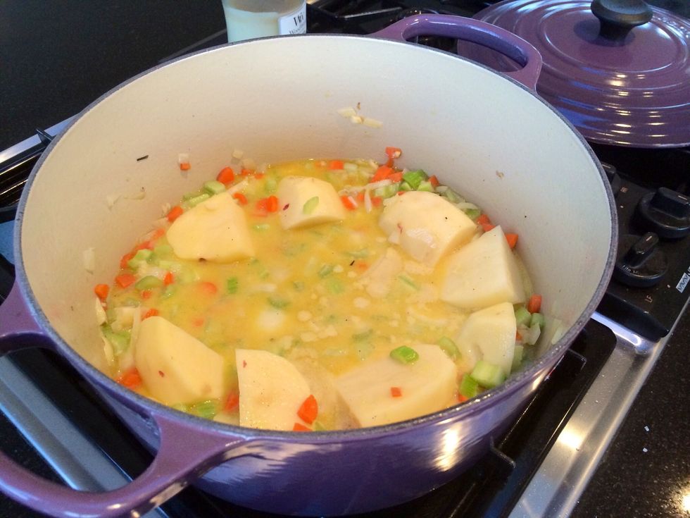 Using the same cocotte add 1-2 Tbs of olive oil then saut\u00e9 onions, carrots and celery. When onions are light and shimmery add garlic, potatoes, chicken stock and mustard mixture. Simmer for 5-10 mins.
