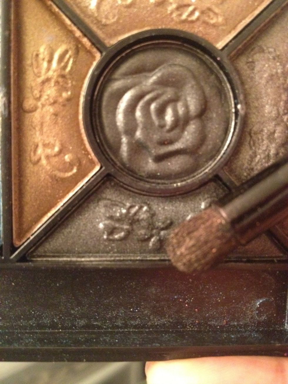 Using the same domed brush we will pick up this black eyeshadow, lightly just a quick tap. It's easier to build black then have too much and try to blend out!