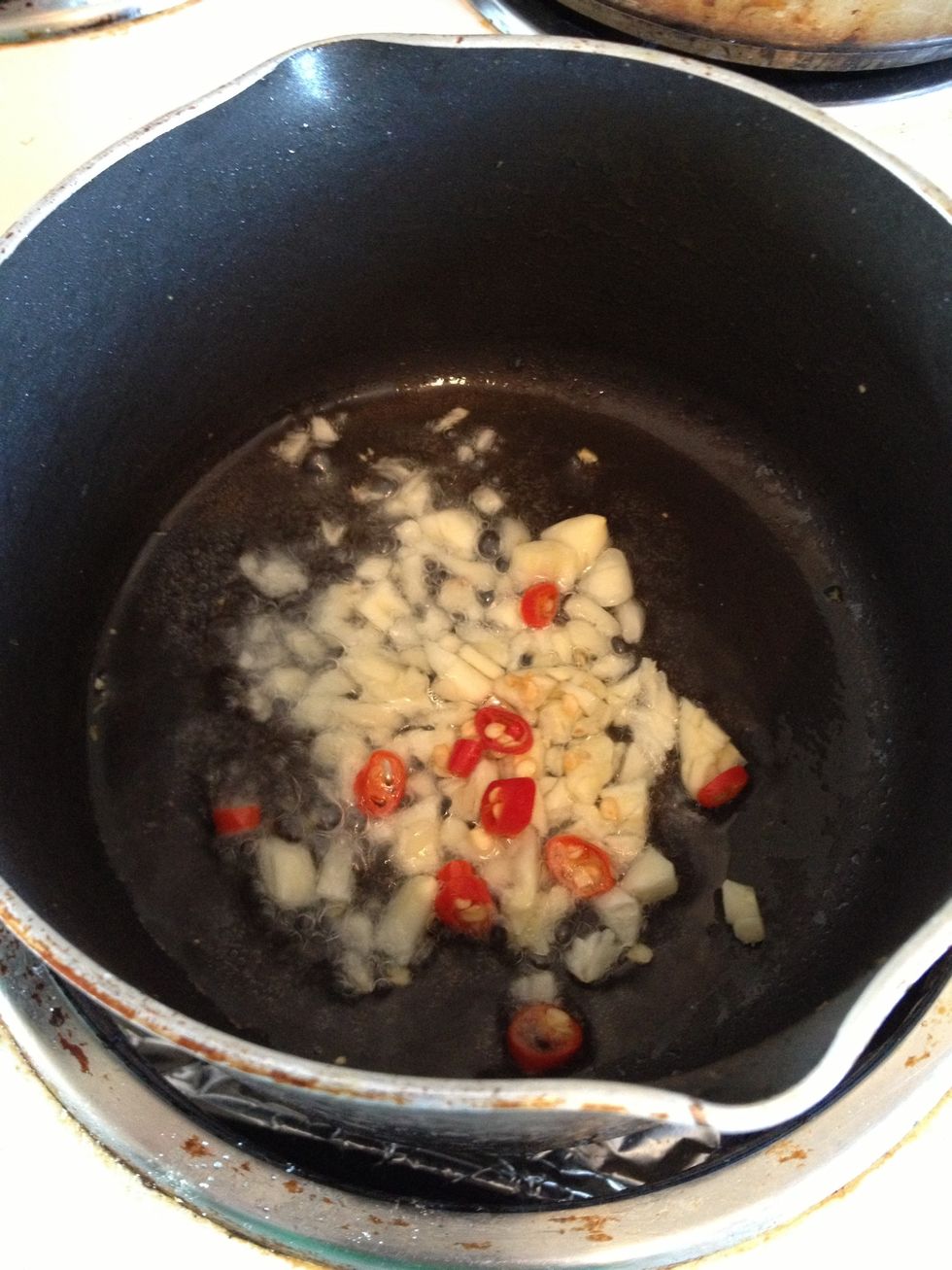 Using the same pan, add some more oil to brown garlic and chili