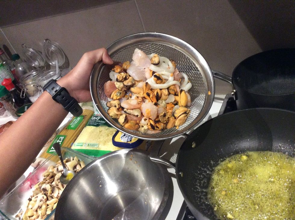 Using the same pot, put another 2-5 teaspoons of butter. Then, chuck all of the seafood mix in and mix for 2-3 minutes.