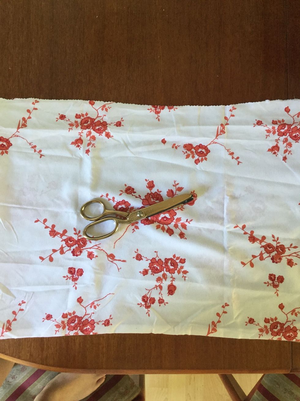 Using the scissors, cut along where the pins are. If an edge is sewn up on the fabric you are using, cut along it. If you don't, the bag won't work.