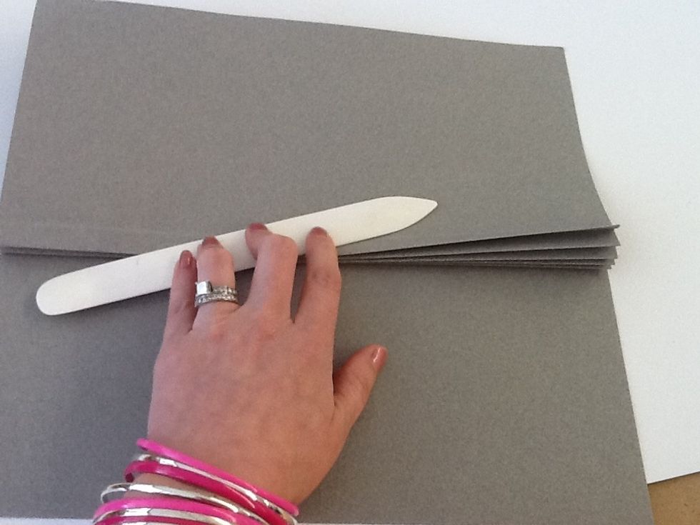 Using the scored lines as a guide, accordion fold the seams and smooth over with a bone folder.