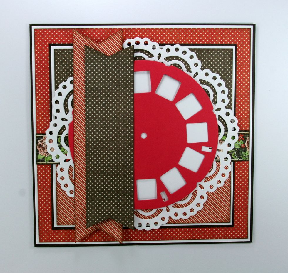 Using the scraps from the patterned papers already used....cut 2 thin strips and snip a dovetail. Attach with the top slightly set off the first.