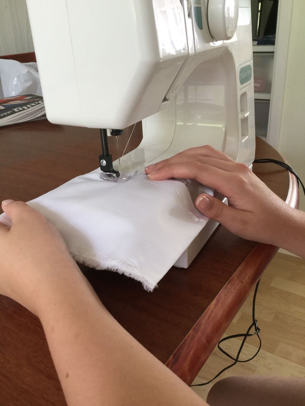 Using the sewing machine sew up the sides of the case that you tacked. Start at the begging with a back stitch and end with back stitch. Do this on both bits of material.