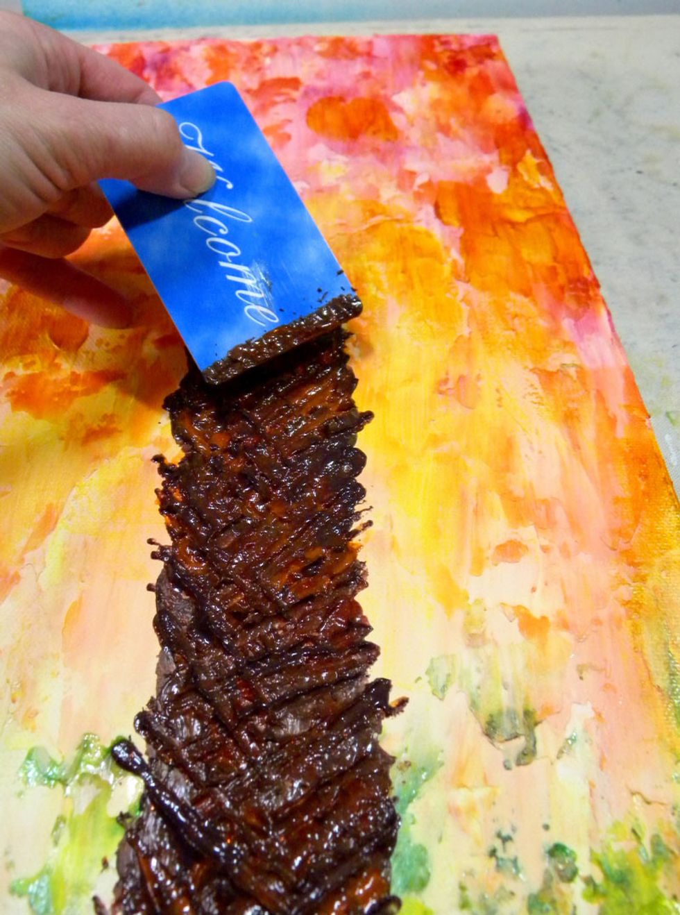 Using the short edge of a key card, create the criss-cross pattern while the paint is still wet, adding more paint if needed.  Add highlights using Portobello and Tango Velvets.