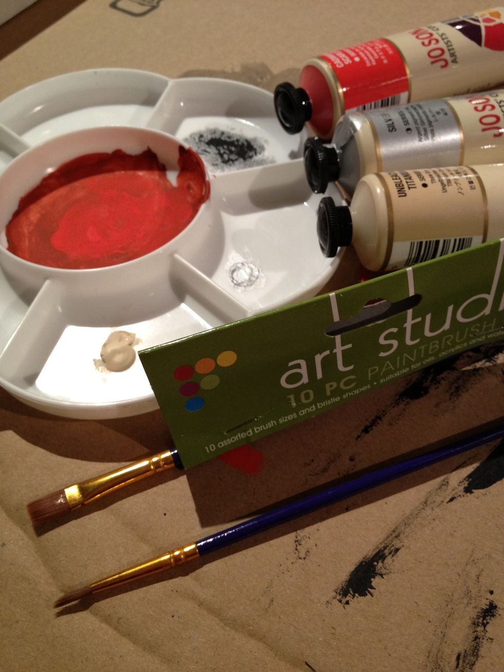 Using the Size 4 Flat brush and the Cadmium Scarlet paint (with a little black added if you want to tone down the scarlet a bit), paint the name of the city across the bottom of the canvas block