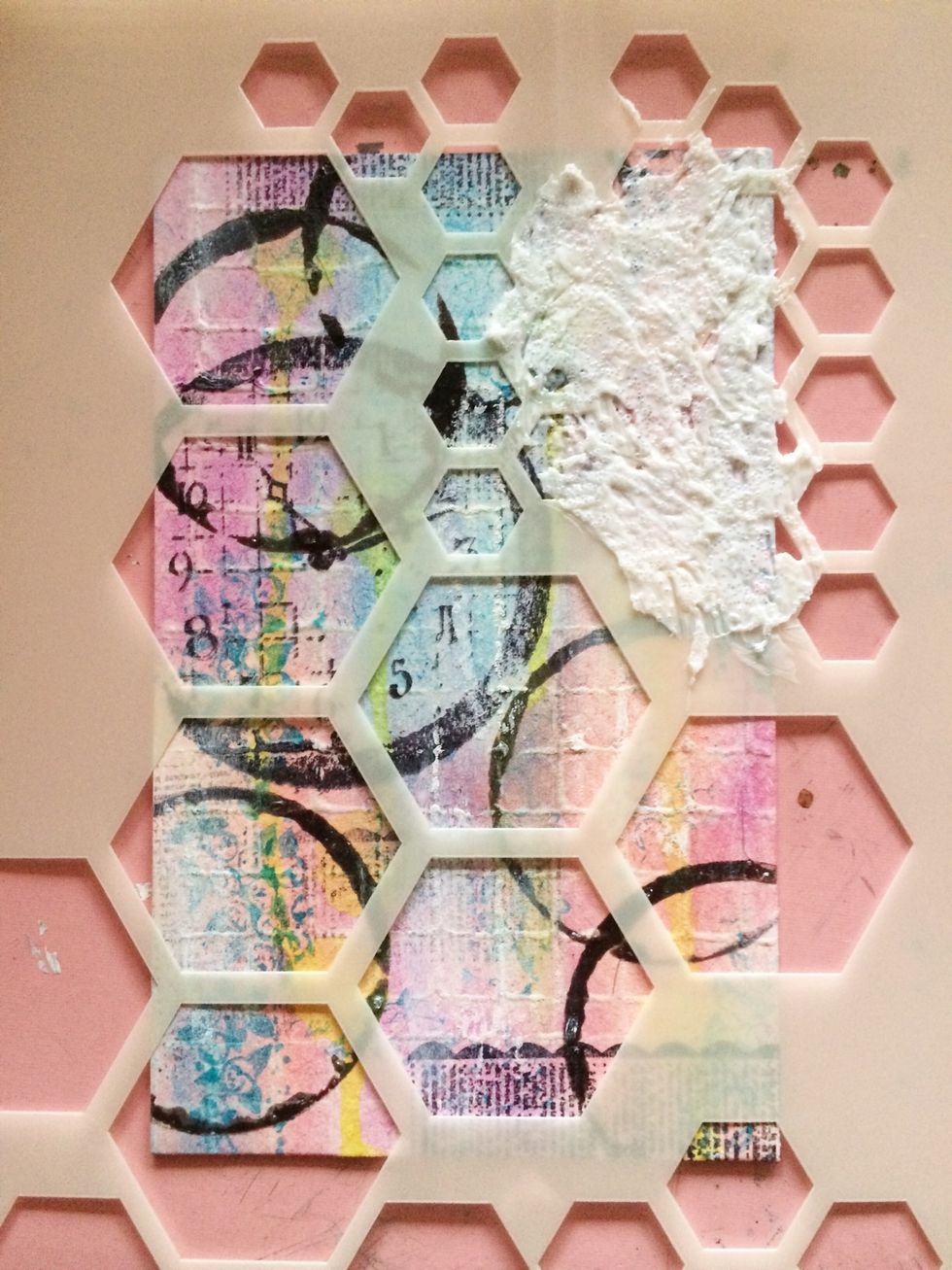 Using the smallest hexagon on the Crafter's Workshop Hexagon stencil. Scrape your Golden Glass beads through your stencil on the up right and lower left corners.