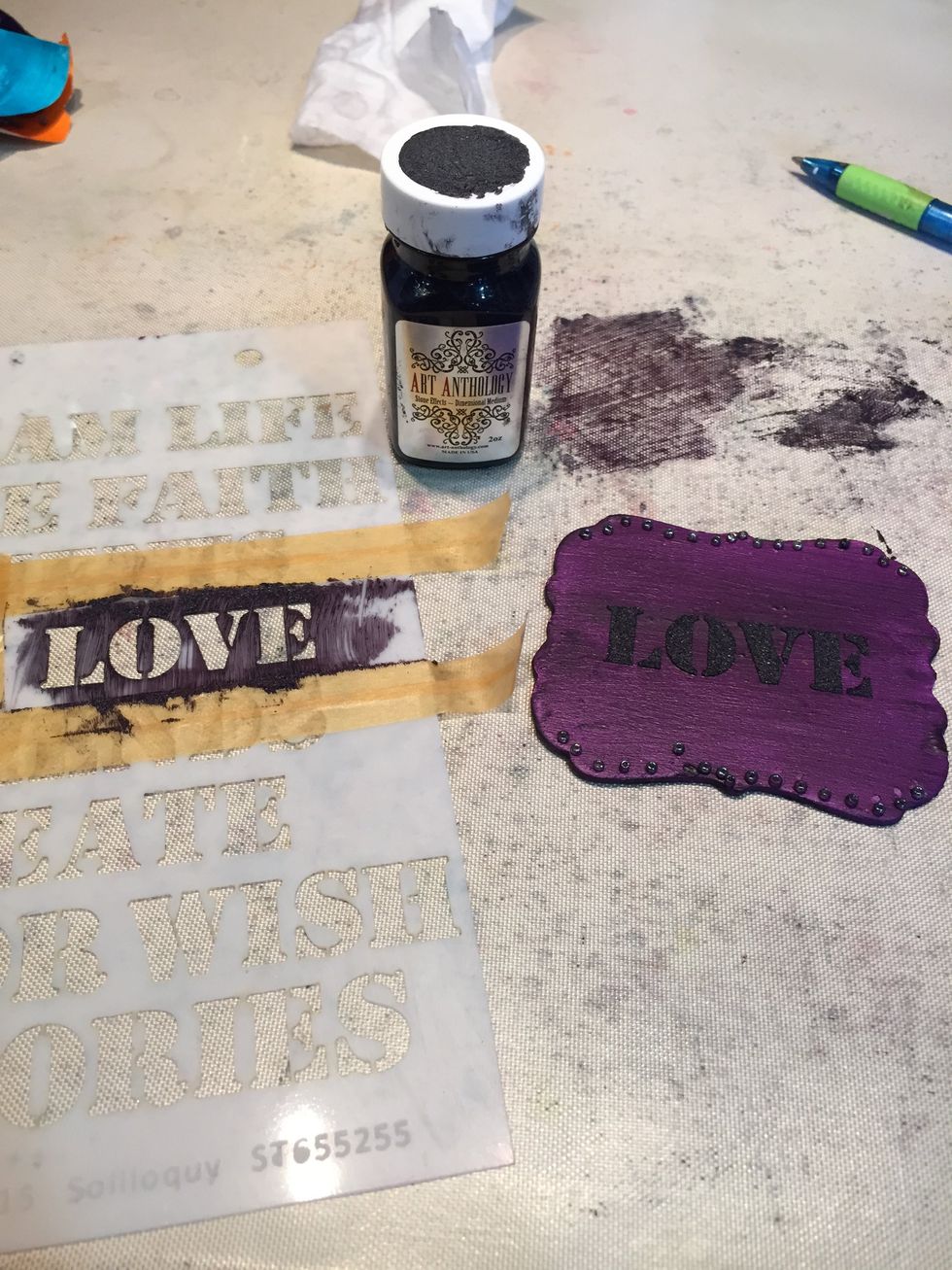 Using the stencil and Lava Stone Effects, add words to each plaque.