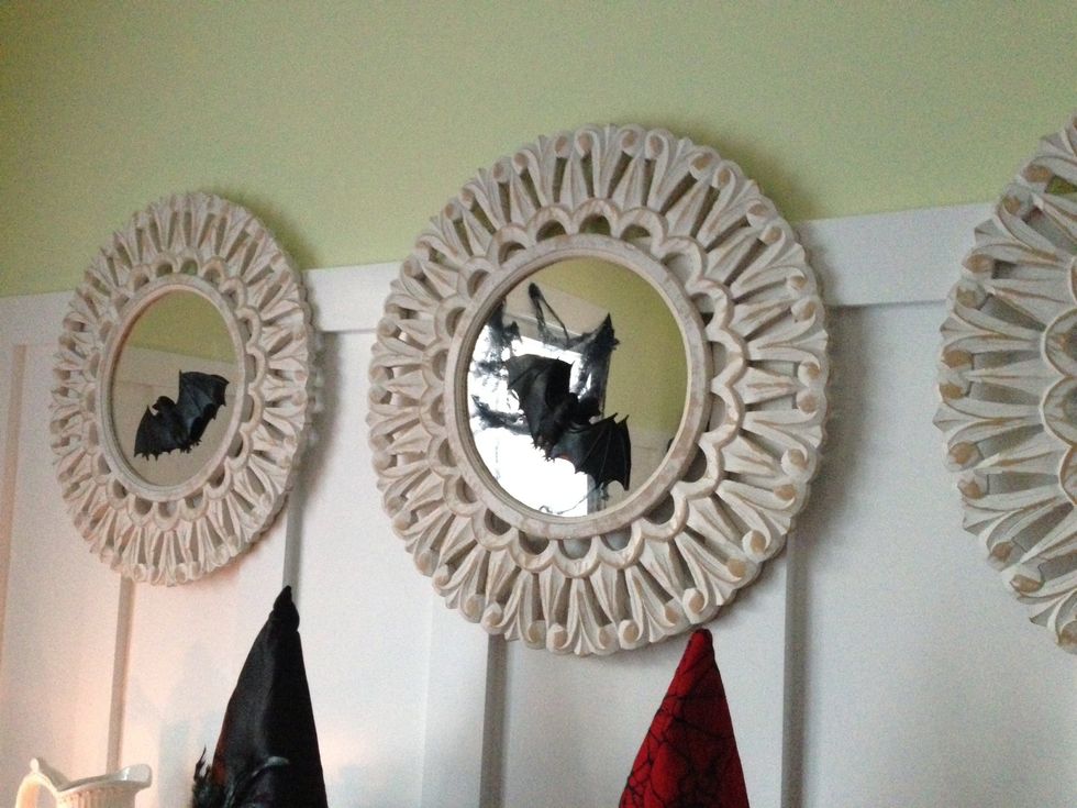 Using the suction cups, stick the rubber bats on the mirrors. If you don't have any mirrors, use a window or affix them to the wall using tape.