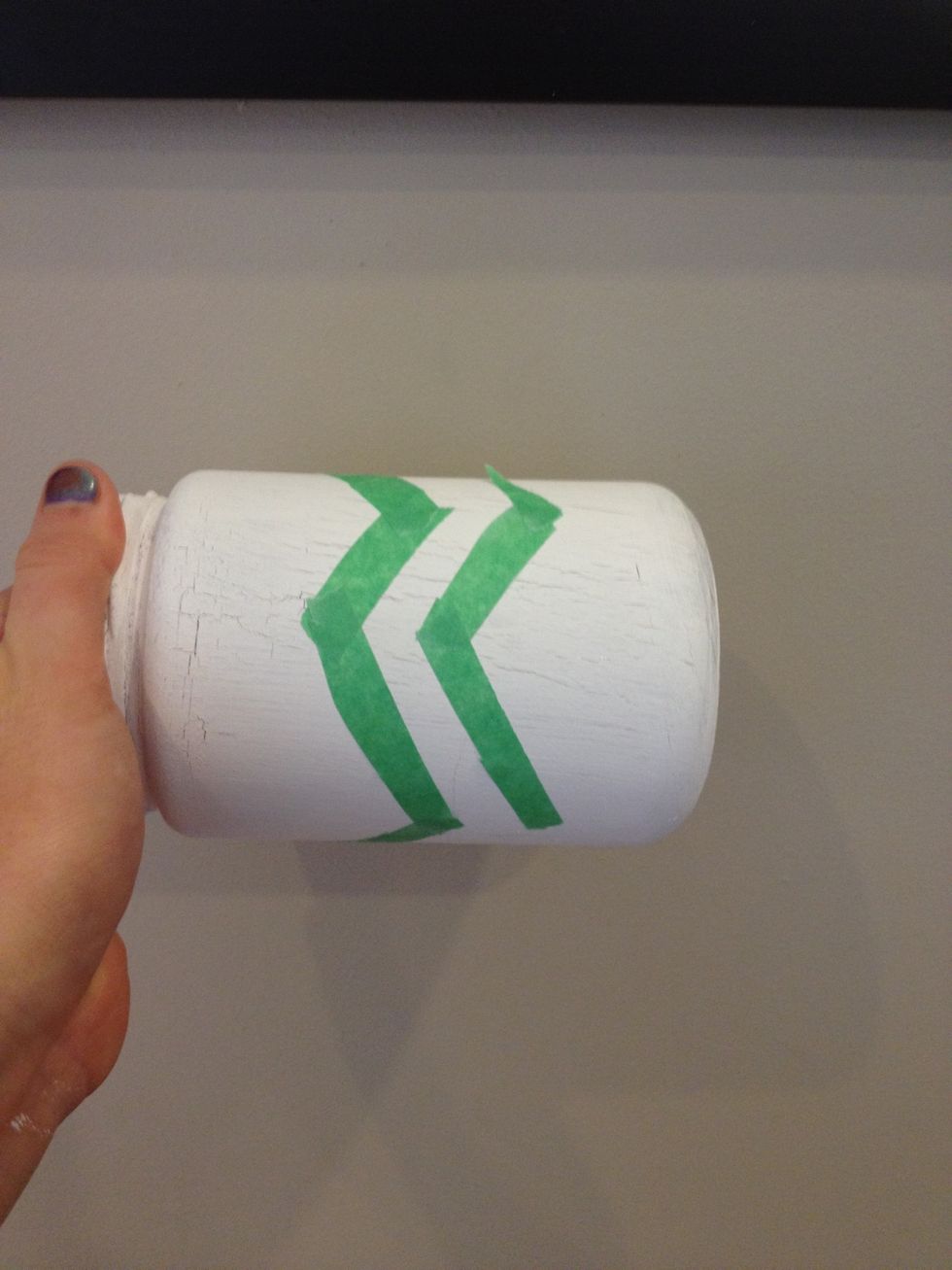 Using the tape, Crete a zigzag pattern on the side of the jar.