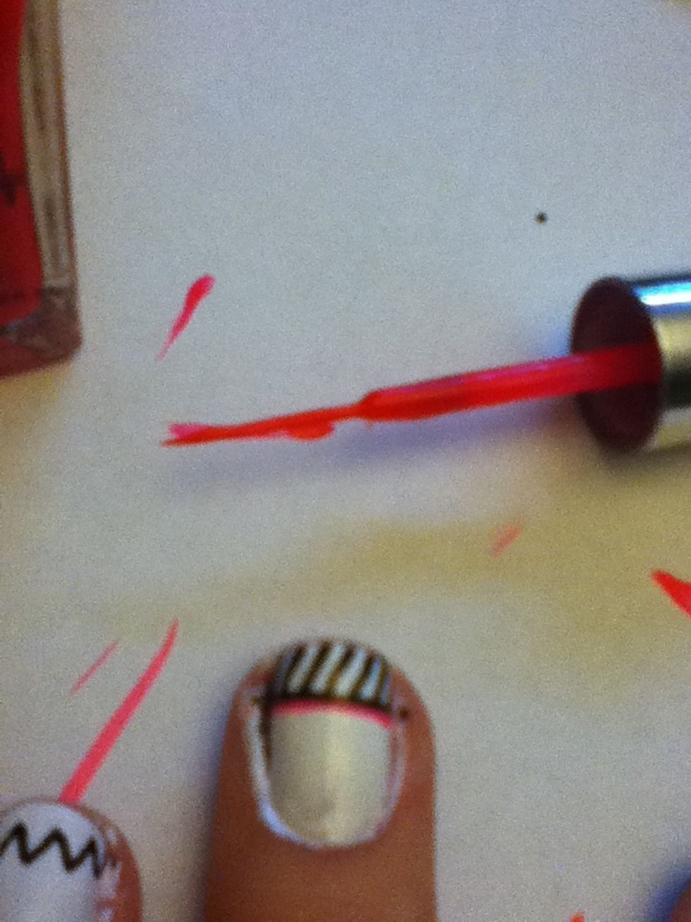 Using the thin brush, paint a thin pink line under the black line.