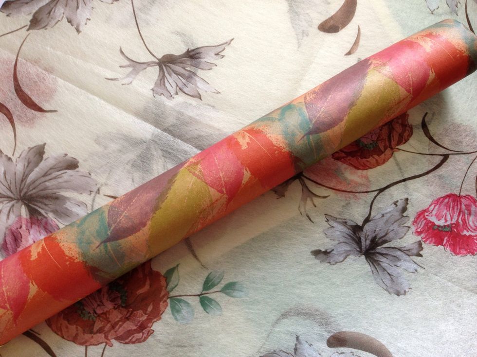 Using the thin gift wrappers , cover the entire board. Make sure that you tightly cover it to prevent the wrapper from moving that may cause your magnets to fall.