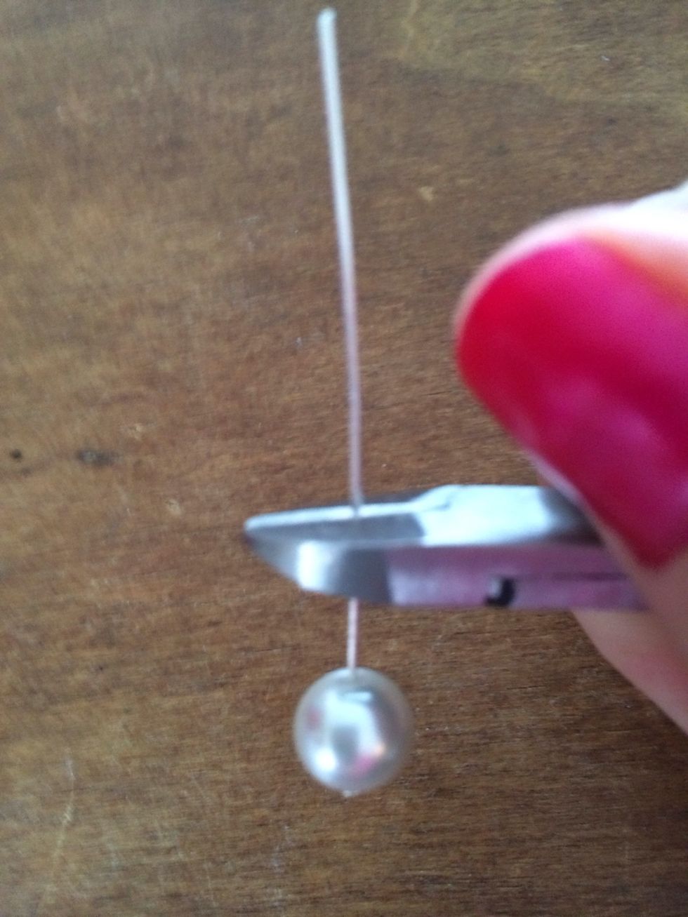 Using the wire cutters, trim the excess wire from above the pearl. Leave approximately 1/4" of wire.