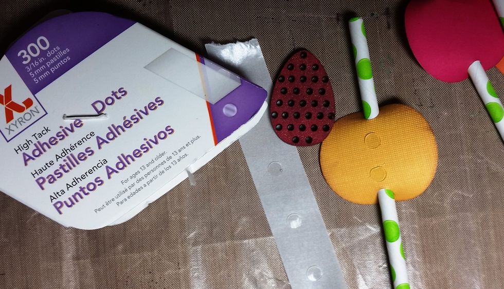 Using the Xyron glue dots I glued the dried wood shape onto the circles.