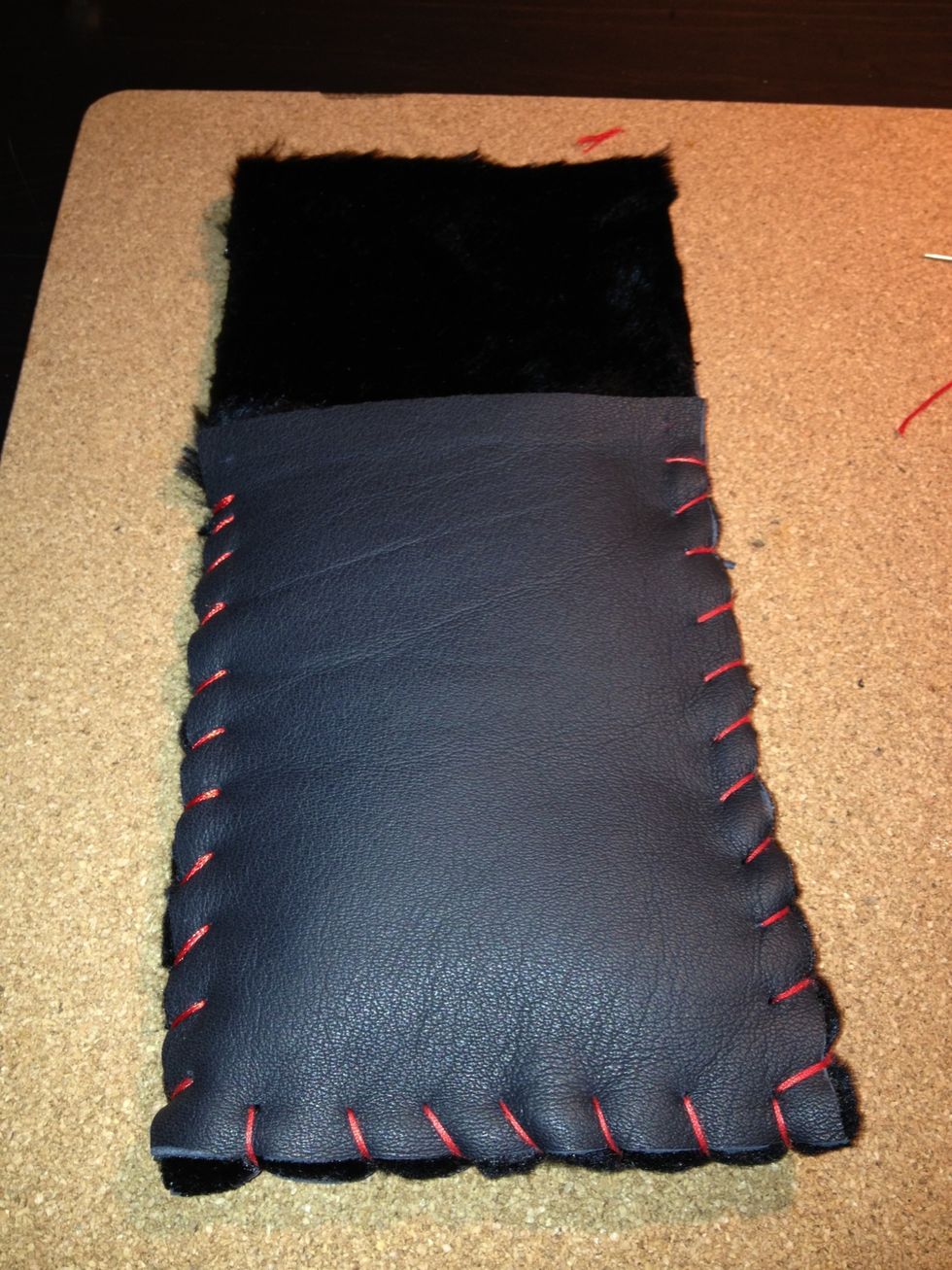 Using thick thread, sew the two leather pieces together. You may use any color you like.