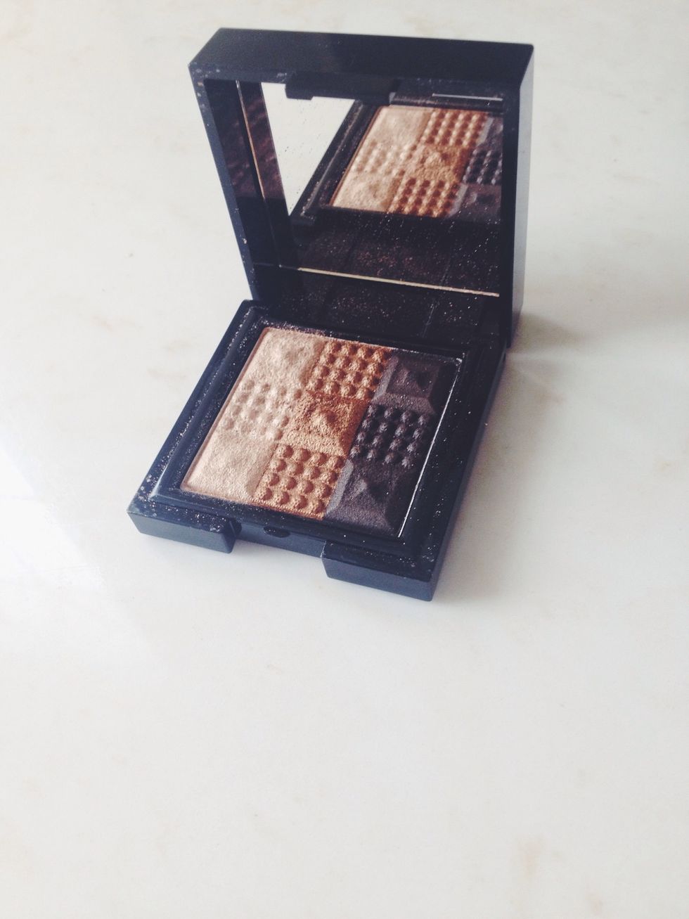 Using this Stila trio I applied kitten over the lid (layering on top the white color from previously) and the dark brown shade in the outer crease to darken it.