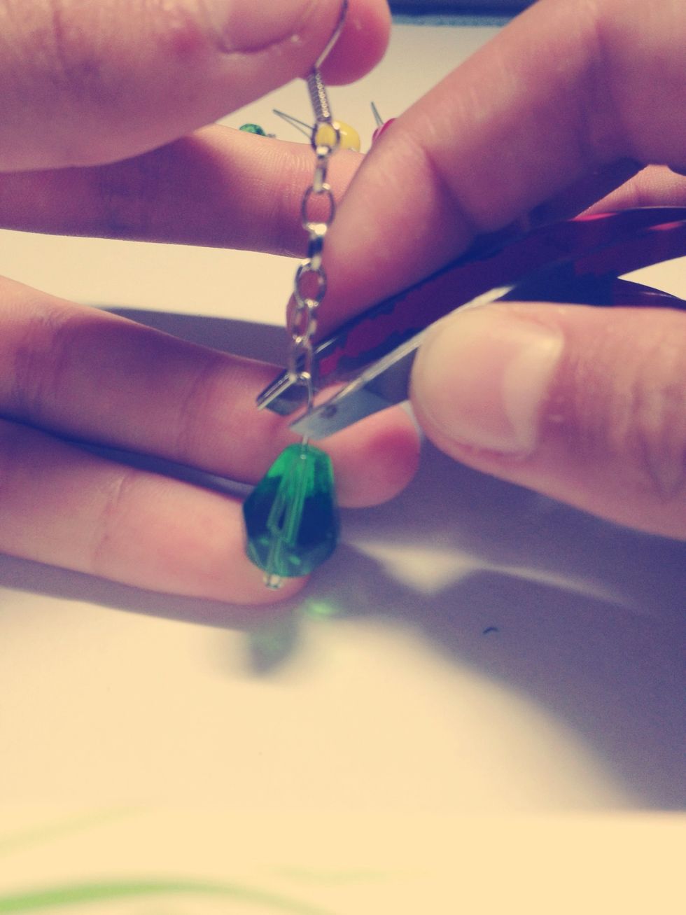 Using tweezers/pliers, close it over the chain so it can't fall off.